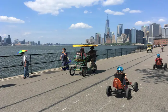 A photo of people walking and riding bikes on Governors Island